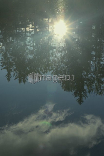 Reflection of clouds in Clear Lake, Riding Mountain National Park; Canada: Manitoba