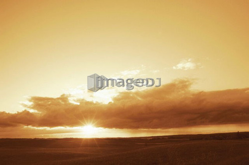 Duotoned sunset over farmland; Canada, Manitoba, Erickson