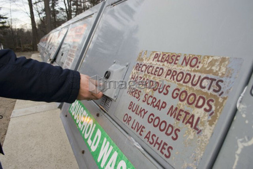 Woman recycling; Canada, Ontario
