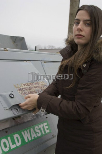 Woman recycling; Canada, Ontario