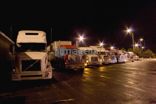 Parking lot for transport trucks at night; Canada, Ontario