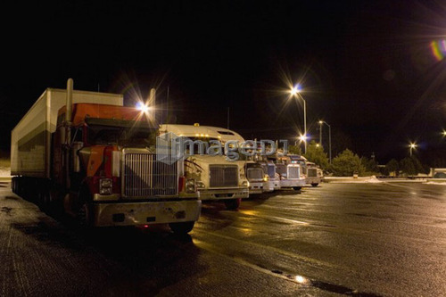 Parking lot for transport trucks at night; Canada, Ontario