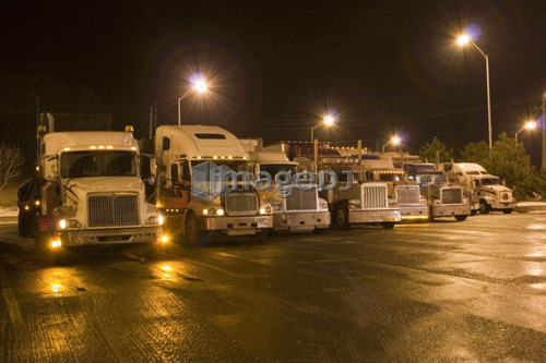 Parking lot for transport trucks at night; Canada, Ontario