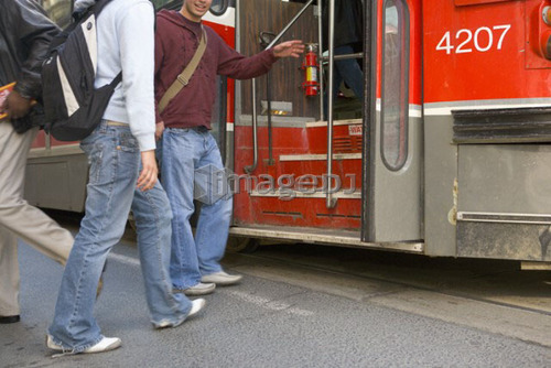 Passengers getting on electric Streetcar, Toronto Transit System, no carbon emissions; Canada, Ontario, Toronto