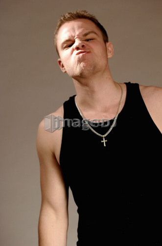 Portrait of young man (21 years of age) snarling; Canada, Saskatchewan, Regina