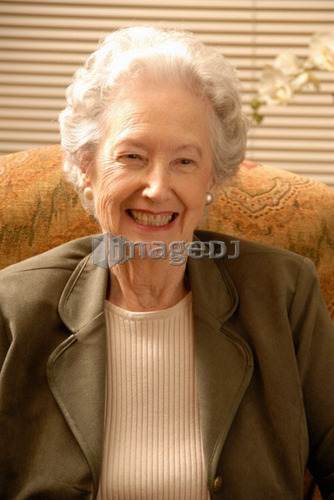 Senior Woman in Armchair; Canada, Saskatchewan, Regina