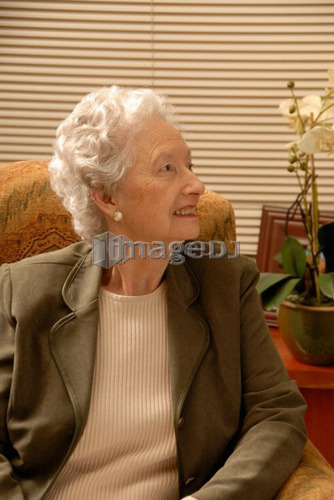 Senior Woman in Armchair; Canada, Saskatchewan, Regina