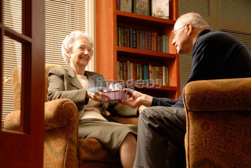 Senior Woman with gift; Canada, Saskatchewan, Regina