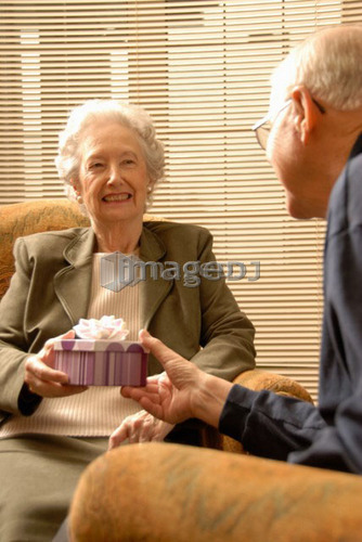 Senior Woman with gift; Canada, Saskatchewan, Regina
