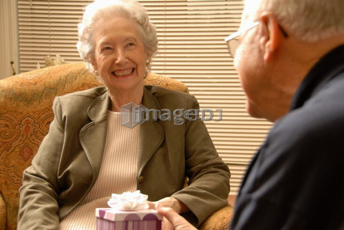 Senior Woman with gift; Canada, Saskatchewan, Regina
