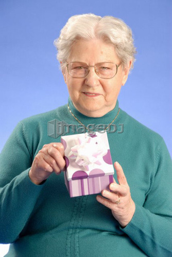 Senior Woman with gift; Canada, Saskatchewan, Regina
