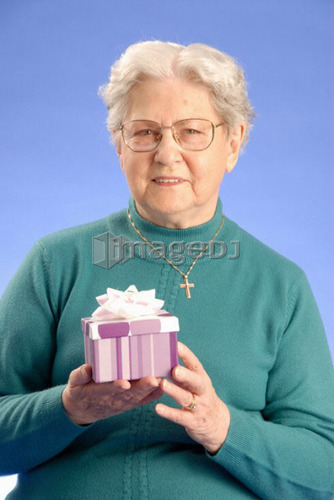 Senior Woman with Gift; Canada, Saskatchewan, Regina