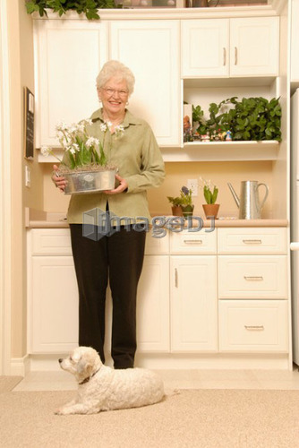 Senior Woman with plants; Canada, Saskatchewan, Regina