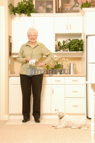 Senior Woman with plants; Canada, Saskatchewan, Regina