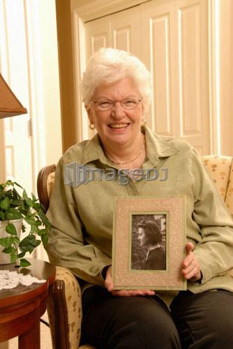 Senior Woman with picture; Canada, Saskatchewan, Regina
