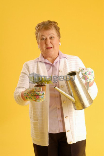 Senior Woman with plants; Canada, Saskatchewan, Regina