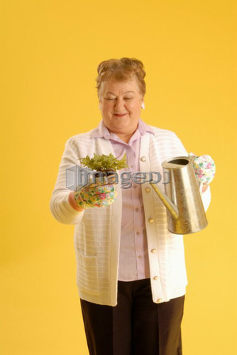 Senior Woman with plants; Canada, Saskatchewan, Regina