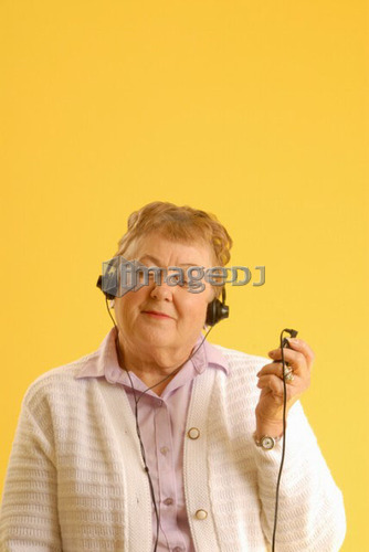 Senior Woman headphones; Canada, Saskatchewan, Regina