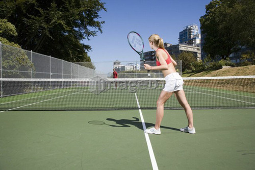 Couple playing tennis; Canada, British Columbia, Vancouver