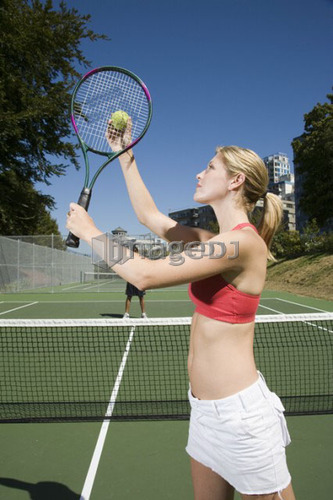 Couple playing tennis; Canada, British Columbia, Vancouver