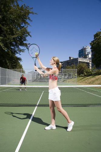 Couple playing tennis; Canada, British Columbia, Vancouver
