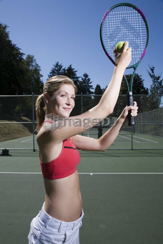 Woman readies to serve at tennis; Canada, British Columbia, Vancouver