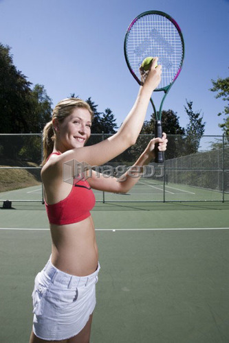 Woman readies to serve at tennis; Canada, British Columbia, Vancouver