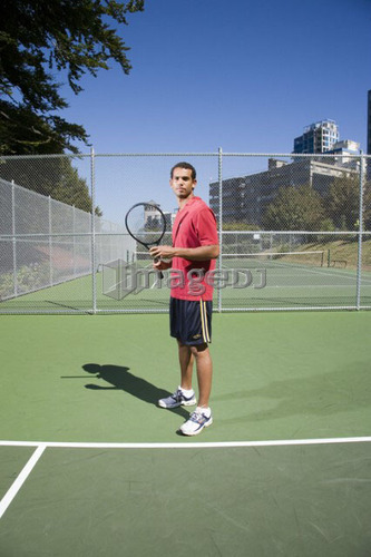 Man on tennis court; Canada, British Columbia, Vancouver
