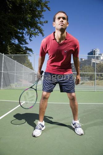 Man on tennis court; Canada, British Columbia, Vancouver