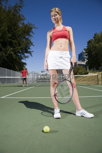 Couple on tennis court; Canada, British Columbia, Vancouver