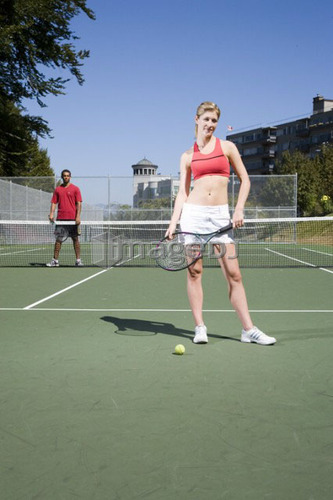 Couple on tennis court; Canada, British Columbia, Vancouver