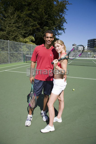 Couple on tennis court; Canada, British Columbia, Vancouver