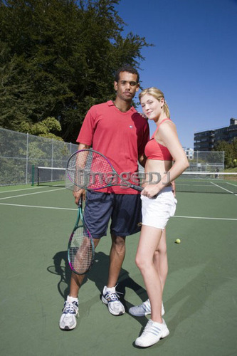 Couple on tennis court; Canada, British Columbia, Vancouver