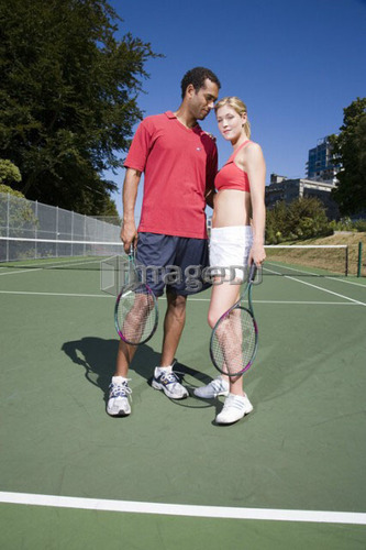 Couple on tennis court; Canada, British Columbia, Vancouver