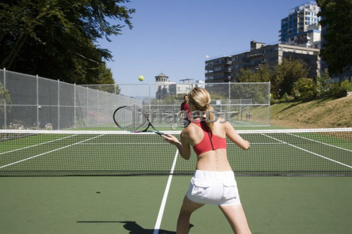 Couple playing tennis; Canada, British Columbia, Vancouver