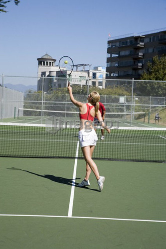 Couple playing tennis; Canada, British Columbia, Vancouver