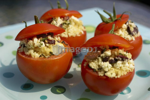 Stuffed tomato appetizer on polka-dotted turquoise plate, Canada, Ontario