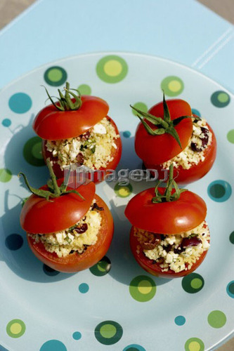 Stuffed tomato appetizer on polka-dotted turquoise plate, Canada, Ontario