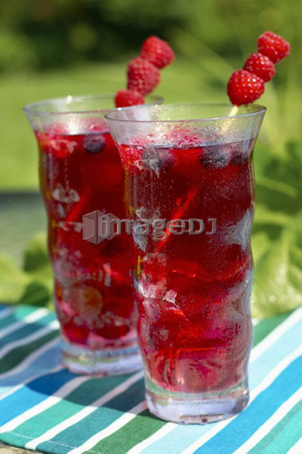 Two glasses of fruit juice garnished with raspberries, Canada, Ontario