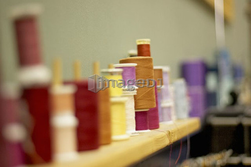 Spools of thread lined along the wall on a shelf, Canada, Ontario