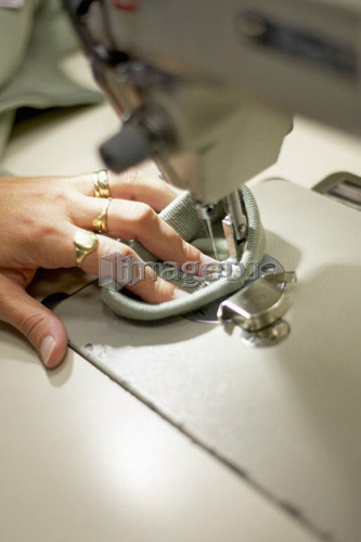 Detail of hand sewing fabric on a sewing machine, Canada, Ontario