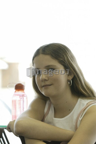 Portrait of pre-teen girl, wearing shirt made with hemp fibre, with reusable water bottle, Canada, Manitoba, Brandon
