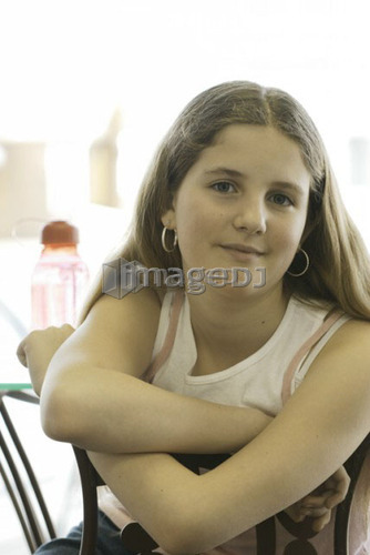 Portrait of pre-teen girl, wearing shirt made with hemp fibre, with reusable water bottle, Canada, Manitoba, Brandon
