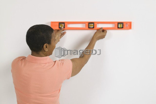 African American Woman Doing Home Improvement, Using a Spirit Level, Canada, British Columbia