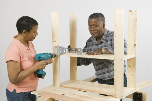 African American Couple Doing Home Improvement, Assembling a Shelving Unit, Canada, British Columbia