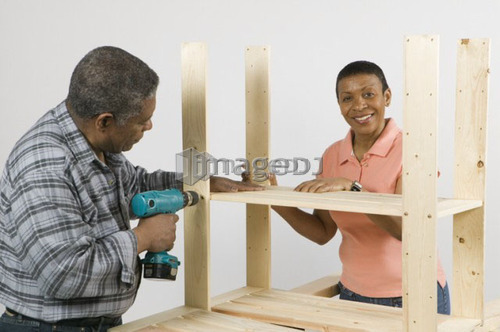 African American Couple Doing Home Improvement, Assembling a Shelving Unit, Canada, British Columbia