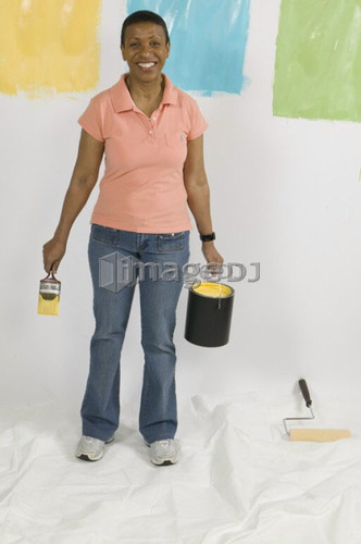 African American Woman Doing Home Improvement Painting, Canada, British Columbia