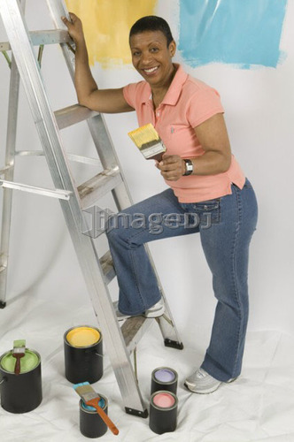 African American Woman Doing Home Improvement Painting, Canada, British Columbia