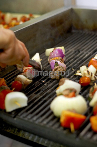 Shish kabobs cooking on a grill