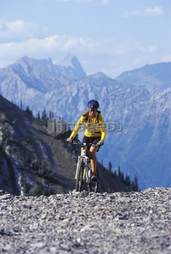 Young woman mountain biking at Fernie Alpine Resort, Fernie, BC, Canada